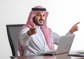 Arab businessman pointing at laptop on white background photo