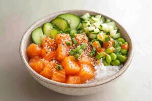 Salmon poke bowl with fresh vegetables and rice served in a textured ceramic dish photo