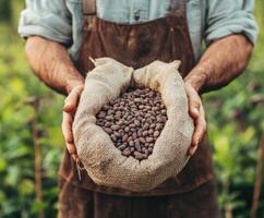 Farmer holds burlap sack filled with freshly harvested cocoa beans in lush plantation environment photo