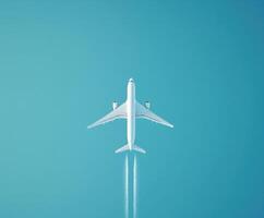 Airplane flying high in a clear blue sky, leaving a white contrail behind during a sunny day photo