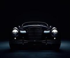 Classic luxury car displayed dramatically under low lighting in a studio setting photo