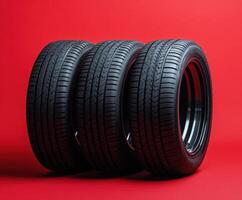 High-performance tires arranged on a vibrant red background showcasing their tread and design details photo