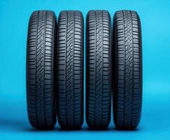 Quality tires arranged in a row on a blue background showcasing their tread patterns and structure photo