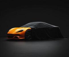 Brand new sports car partially covered with a black cloth in a dark studio setting photo