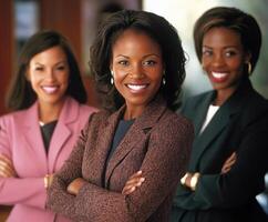 Professional women confidently posing together in an office setting during a sunny day photo