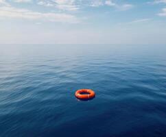 Floating life ring in a calm blue ocean under a clear sky during midday photo