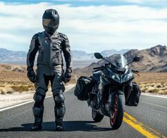 Motorcyclist in leather suit stands confidently beside sportbike on open road in desert landscape photo