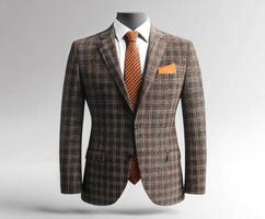 Stylish menswear featuring a plaid blazer, crisp shirt, and patterned tie on a display mannequin with a neutral background photo