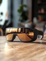 Modern sunglasses reflecting sunset road on wooden table photo