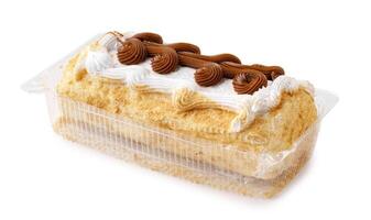 Dessert with layers of cream and chocolate frosting on a light cake base photo