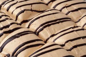 Delicious dessert featuring layers of creamy caramel and chocolate drizzle in a dessert display photo