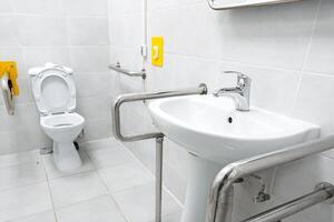 Accessible restroom featuring grab bars and modern fixtures for inclusive use photo