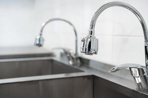 Modern kitchen sinks and faucets showcase sleek design and functionality in a contemporary environment with a minimalistic style photo