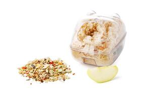 Nutritious seed mix served in a bowl with additional snacks for pet at home photo