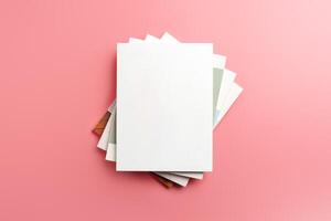 A Collection of Blank Papers Stacked on a Pink Surface for Creative Projects photo