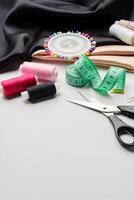Crafting essentials for sewing projects displayed on a table with fabric, threads, and tools photo