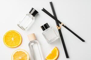 Aromatic display of essential oils with citrus fruit and chopsticks on a minimalist background photo