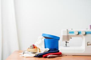 A sewing machine with colorful threads and fabric in a bright crafting space for creative projects photo