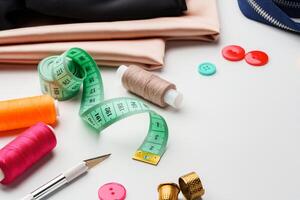 Crafting essentials for sewing projects displayed on a table with fabric, threads, and tools photo