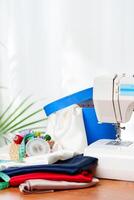 A sewing machine with colorful threads and fabric in a bright crafting space for creative projects photo