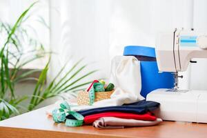 A sewing machine with colorful threads and fabric in a bright crafting space for creative projects photo