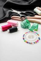 Crafting essentials for sewing projects displayed on a table with fabric, threads, and tools photo