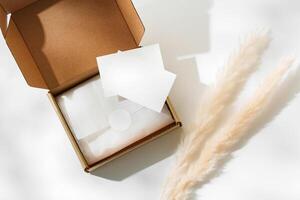 Delivery package with a blank envelope and decorative elements on a light background photo