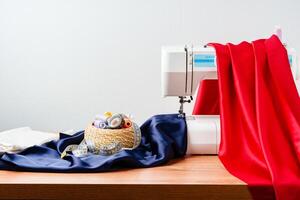 Sewing tools and materials arranged on fabric with a sewing machine in a bright workspace photo