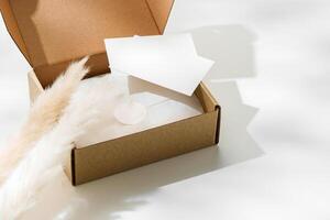 Delivery package with a blank envelope and decorative elements on a light background photo