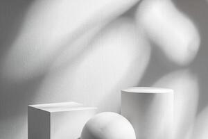Abstract composition featuring three white geometric shapes in a minimalist interior setting photo