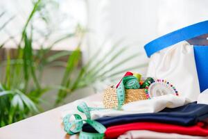 Crafting supplies arranged on a wooden table with colorful threads, measuring tape, and fabric in a well-lit workspace photo