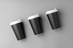 Black disposable cups arranged on a gray surface with white lids, creating a look suitable for a coffee shop setting photo