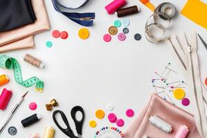 Crafting supplies arranged on a table with fabric, thread and buttons during daytime photo