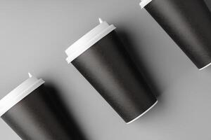 Black disposable cups arranged on a gray surface with white lids, creating a look suitable for a coffee shop setting photo