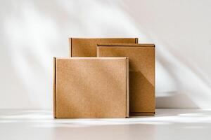 Freshly packed cardboard boxes resting on a white surface, illuminated by soft natural light photo
