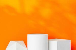 White geometric shapes on a vibrant orange background with soft shadows in a well-lit indoor setting photo