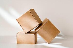 Freshly packed cardboard boxes resting on a white surface, illuminated by soft natural light photo