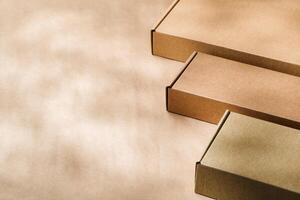 Brown cardboard boxes arranged on a neutral background in a warehouse setting during daylight hours photo