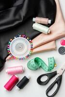 Crafting essentials for sewing projects displayed on a table with fabric, threads, and tools photo