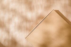 A plain cardboard box on a textured surface with soft light and shadows during the afternoon photo