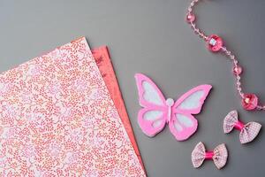 Crafting materials and tools arranged on a gray surface during a creative project photo