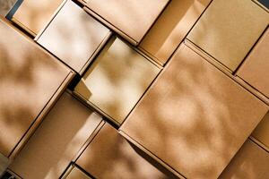 Stacked cardboard boxes arranged in a neat pattern under natural light photo
