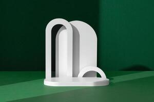 Modern White Architectural Shapes Against A Deep Green Background Displayed On A Simple Table Setting photo
