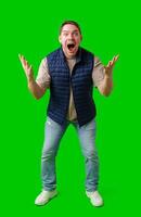 Man celebrating with raised fists in front of a bright green background photo