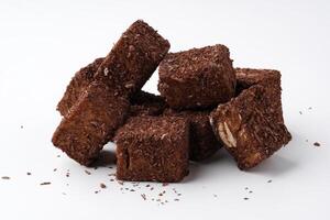 Chocolate treat cubes stacked on a white background showcasing rich texture and appealing appearance photo