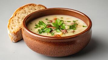 warm bowl of vegetable soup with crusty bread, perfect for comfort photo