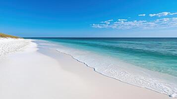 serene beach with white sand and clear blue water under bright sky photo