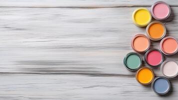 Colorful paint containers arranged on wooden surface, perfect for creativity photo