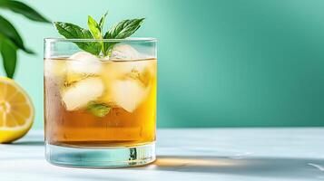 Refreshing iced herbal tea with mint and lemon on bright background photo