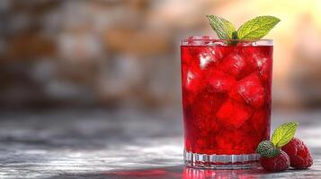 A vibrant raspberry beverage with mint, ice cubes, and fresh raspberries beside it photo
